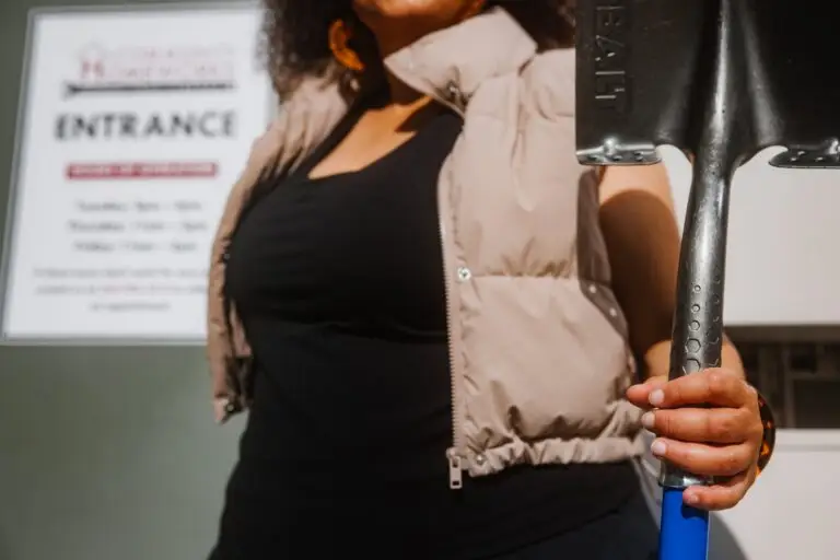 Someone holding a shovel.