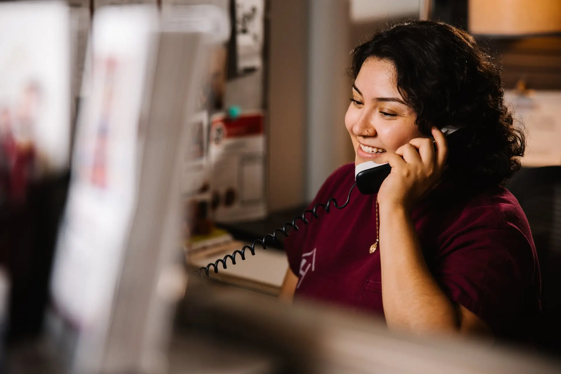 A woman answering a phone.